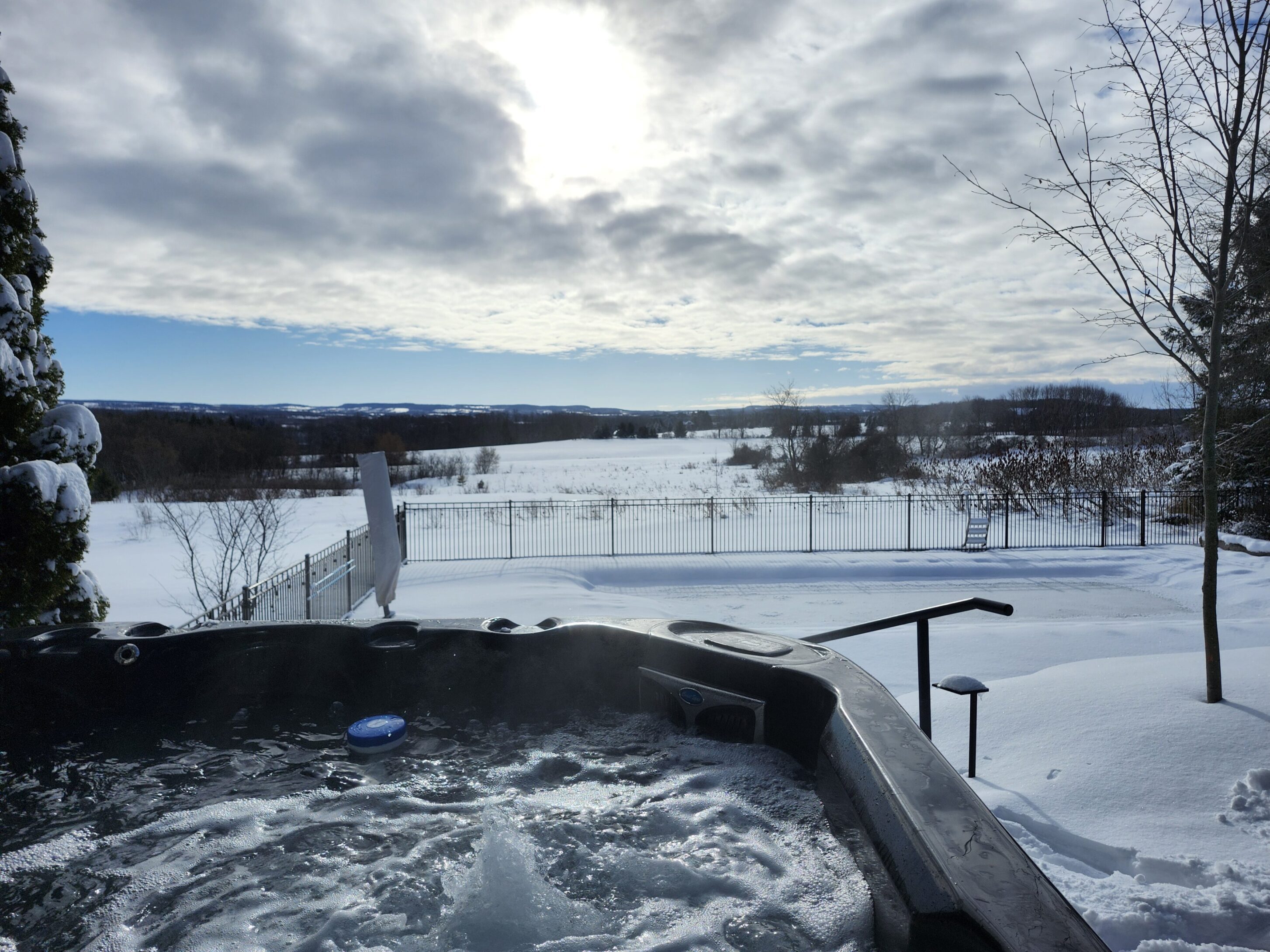 Hot Tub View A hot tub in the middle of snow covered ground.
