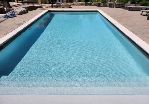 Rectangular swimming pool with clear blue water.