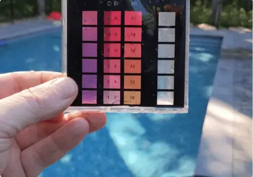 Pool water test kit by a pool.